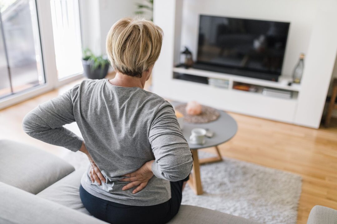 A woman is worried about back pain in the lower back